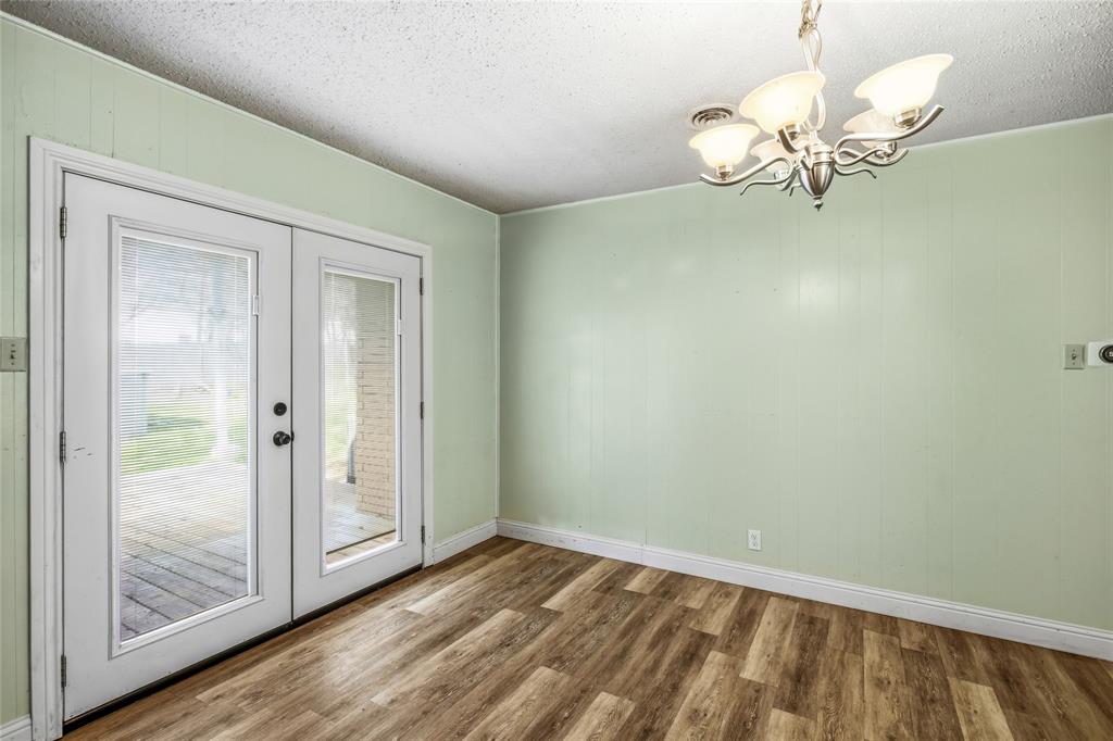 8712 Guadalupe Road Fort Worth, TX 76116 - Photo 10 of 25 a view of a room with wooden floor mirror and windows