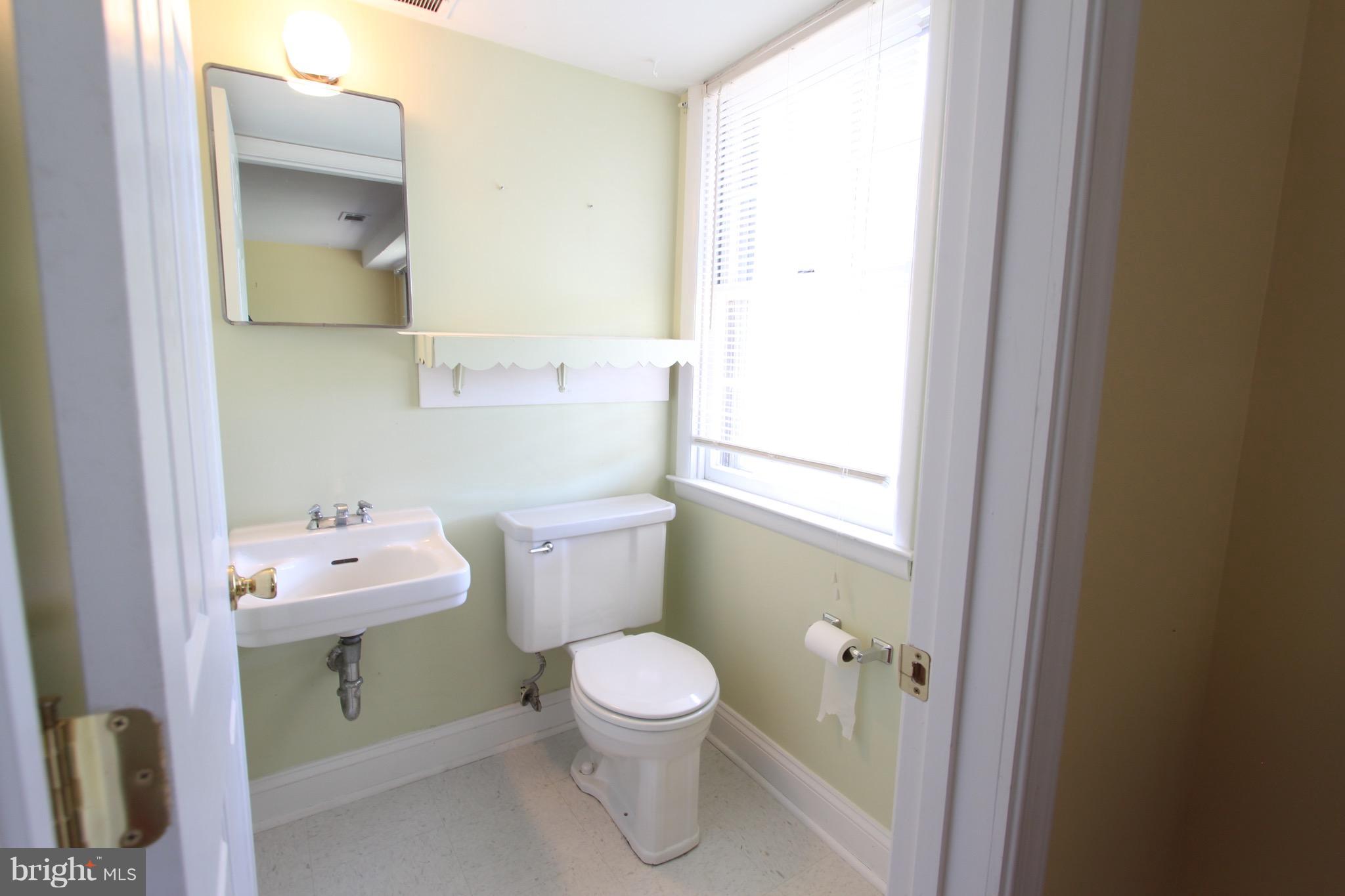 1202 Longford Road Lutherville-Timonium, MD 21093 - Photo 18 of 20 a bathroom with a sink mirror and toilet
