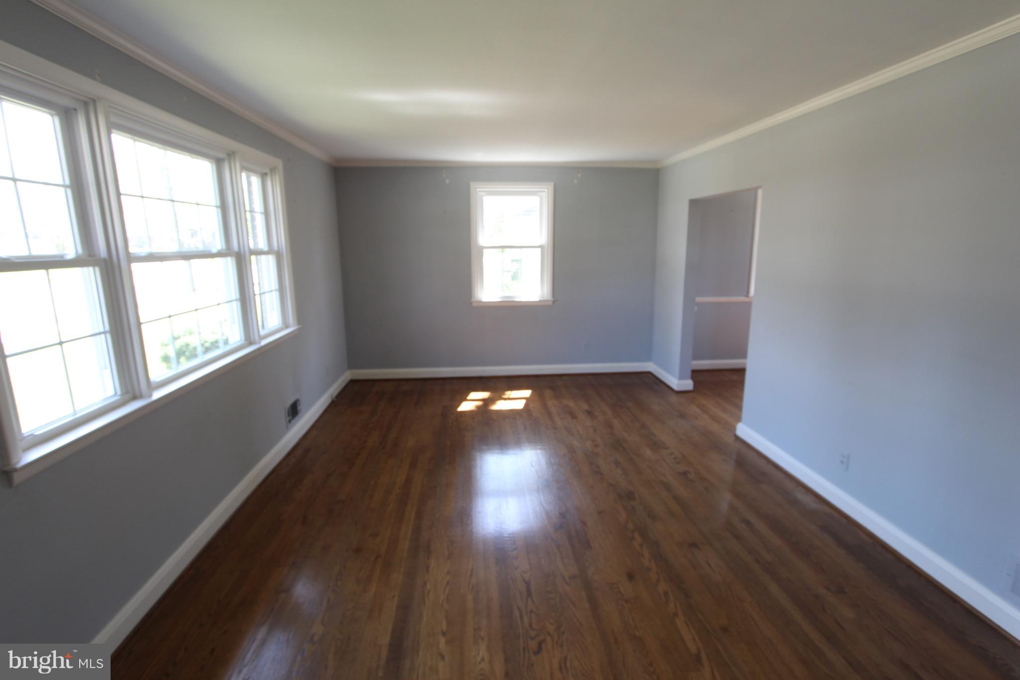 1202 Longford Road Lutherville-Timonium, MD 21093 - Photo 4 of 20 an empty room with wooden floor and windows