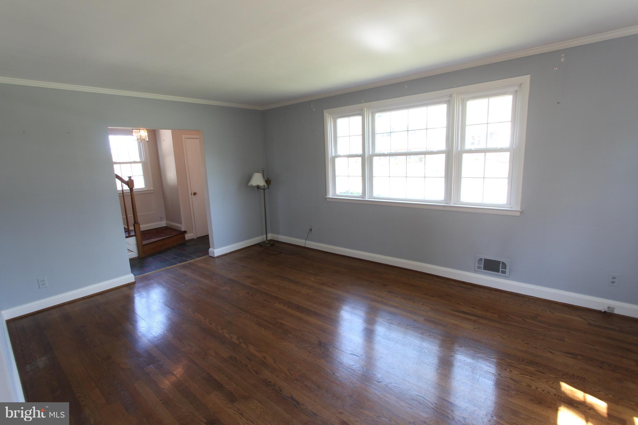 1202 Longford Road Lutherville-Timonium, MD 21093 - Photo 5 of 20 an empty room with wooden floor and windows