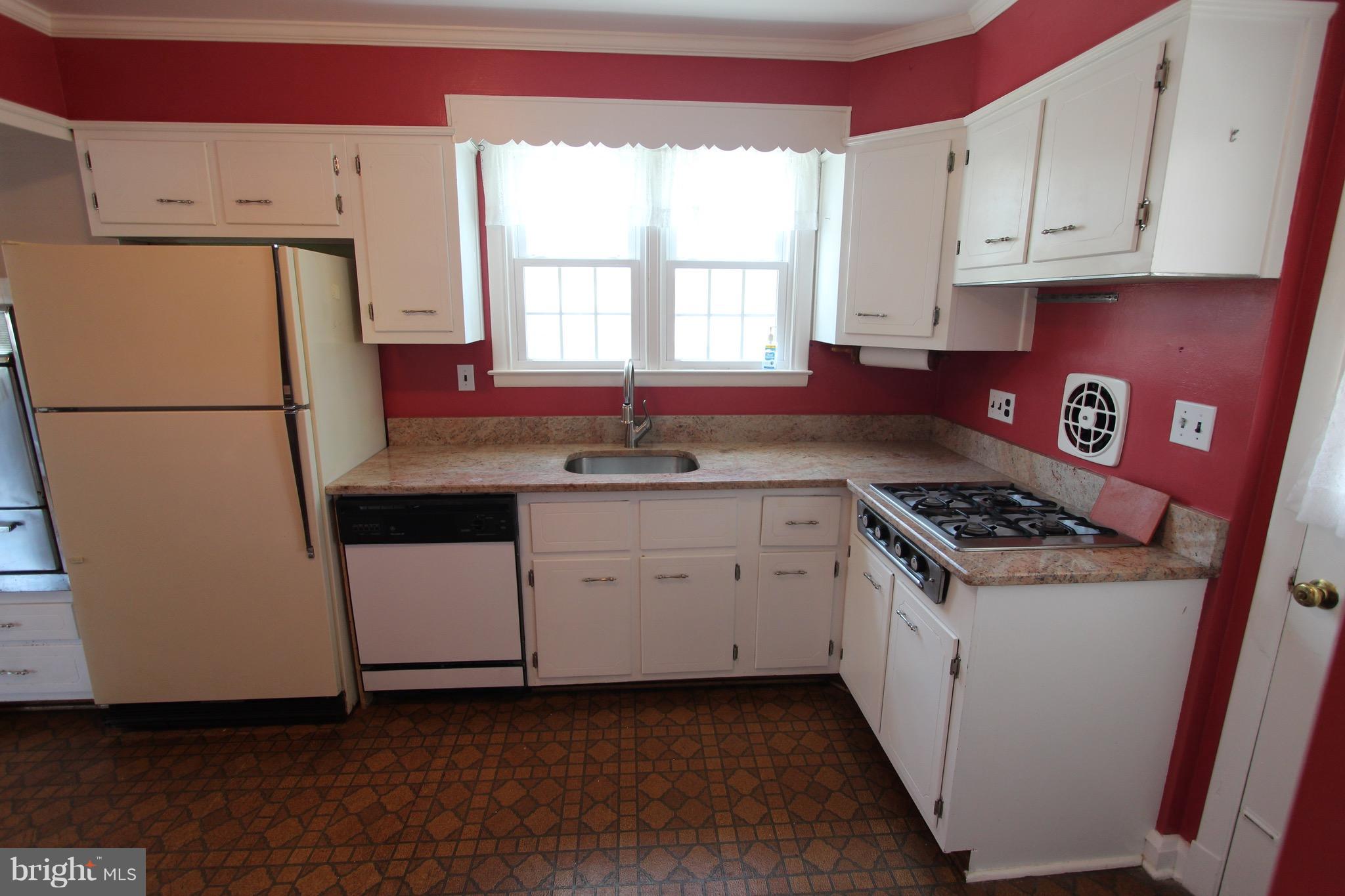 1202 Longford Road Lutherville-Timonium, MD 21093 - Photo 8 of 20 a kitchen with white cabinets sink and white appliances