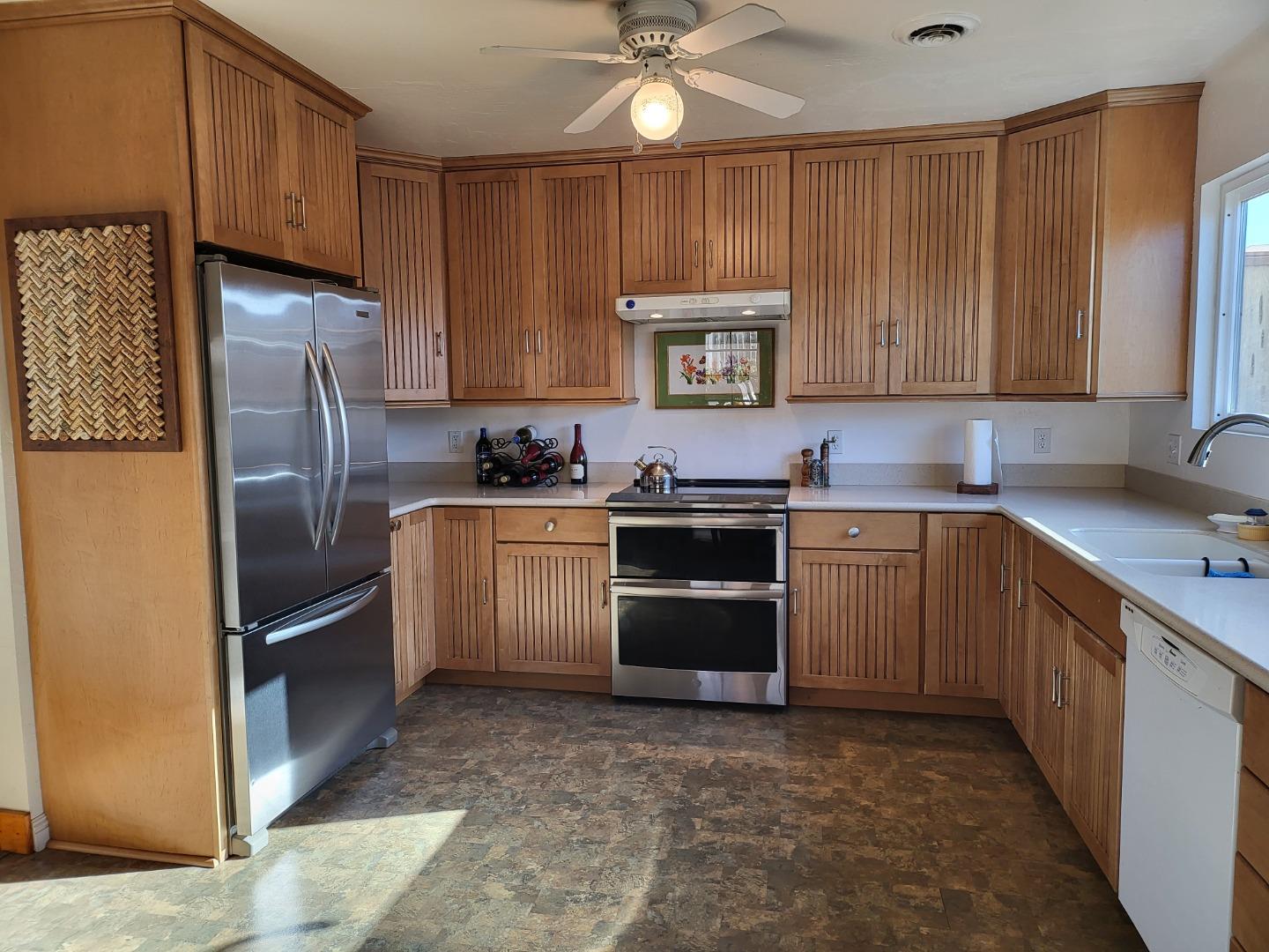 1753 Juarez Street Seaside, CA 93955 - Photo 17 of 52 a kitchen with granite countertop a sink stainless steel appliances and cabinets