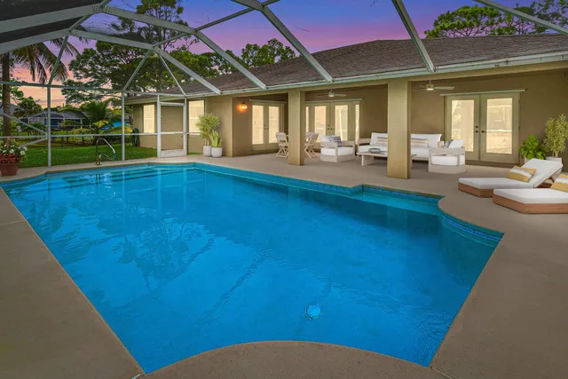 a view of swimming pool with seating space