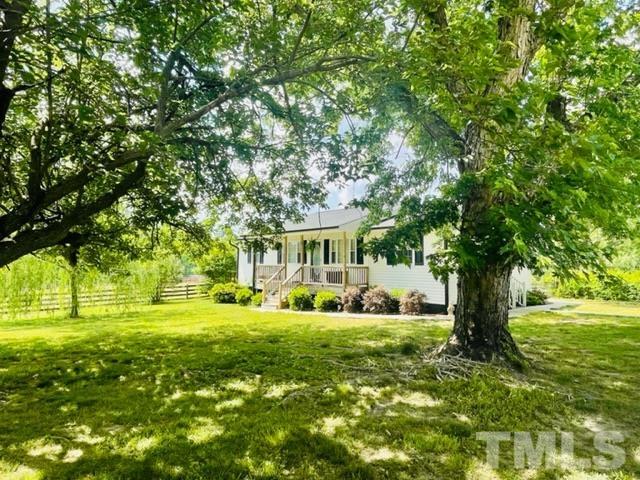459 Cooke Road Louisburg, NC 27549 - Photo 1 of 14 Inviting front porch overlooks gorgeous front yard with mature trees and breathtaking views of the front pasture.