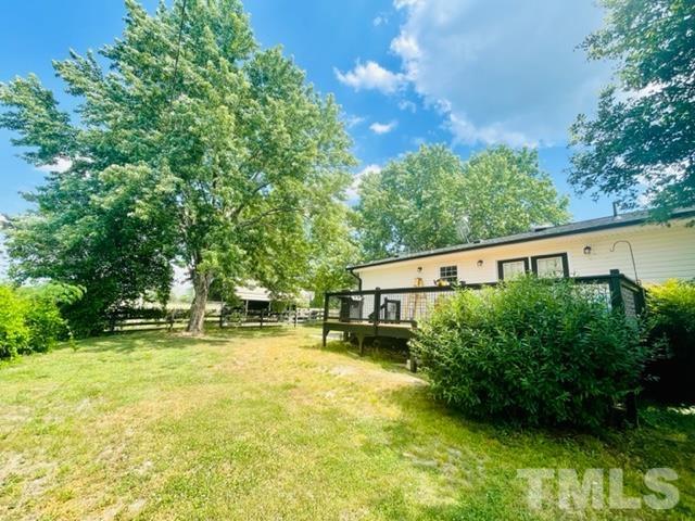 459 Cooke Road Louisburg, NC 27549 - Photo 5 of 14 View of the back of the home. Here you'll find more mature trees, and a beautifully recently upgraded and stained back deck. Perfect for grilling or relaxing on.