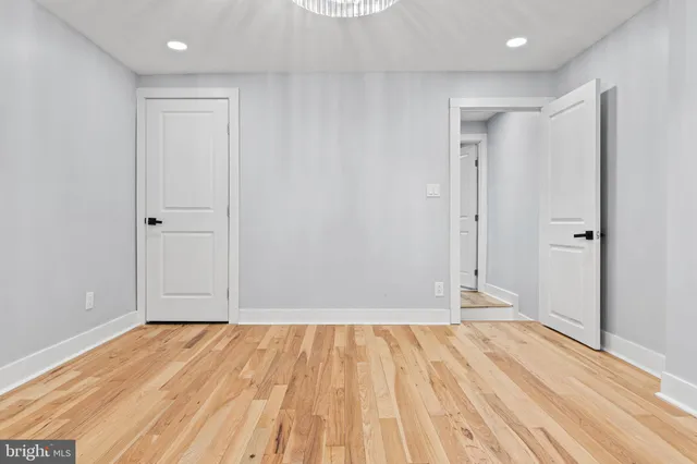 a view of a room with wooden floor and white doors