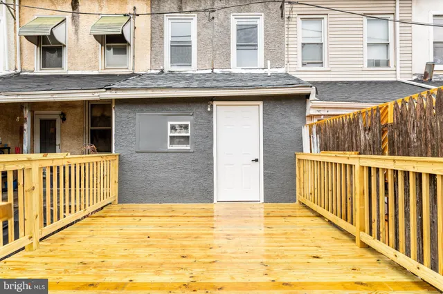 a view of a brick house with many windows