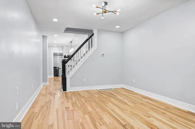 a view of empty room with wooden floor