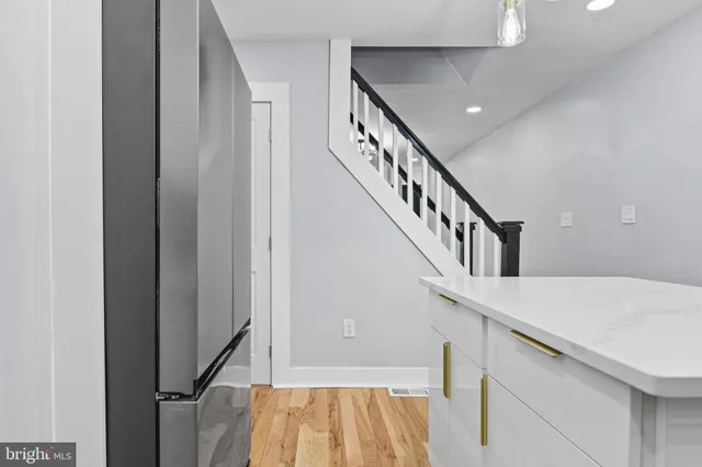 a view of entryway and hall with wooden floor