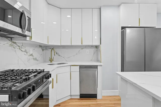 a kitchen with a stove and a refrigerator