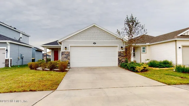 a kitchen with stainless steel appliances granite countertop wooden cabinets a refrigerator and a sink