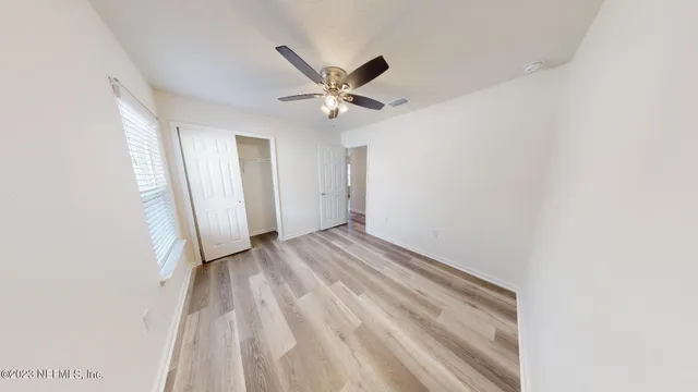 a view of an empty room and a window