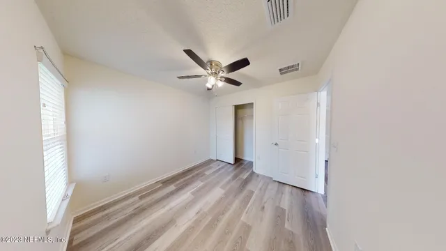 a spacious bathroom with a shower a sink and a mirror