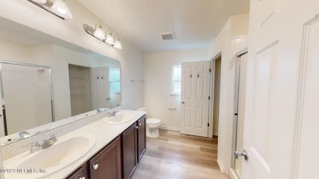 a view of storage and utility room with wooden floor
