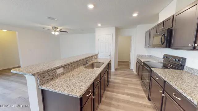 a view of a kitchen with a sink and a window