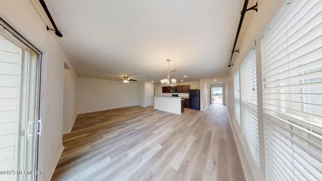 a view of a livingroom with a ceiling fan and window