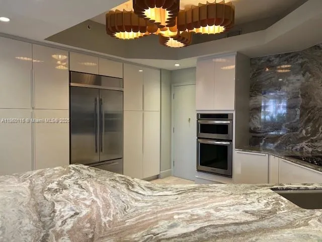 a kitchen with granite countertop a sink and cabinets