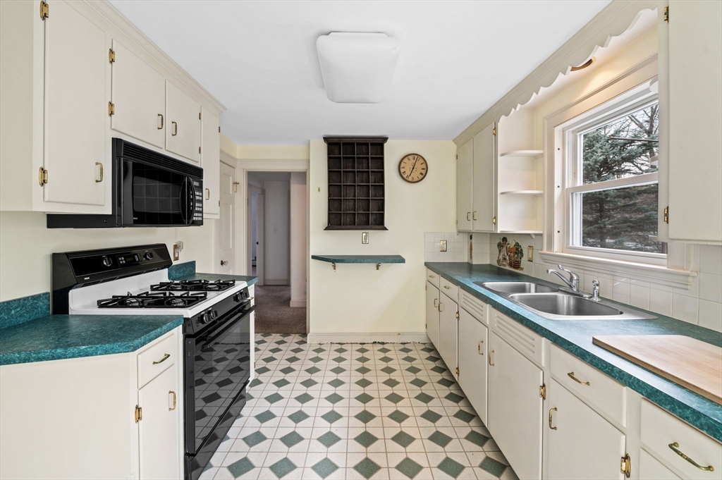 5 Prospect Street Danvers, MA 01923 - Photo 11 of 42 a kitchen with stainless steel appliances a stove a sink a stove and a microwave