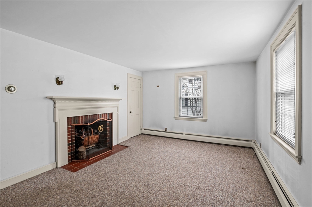 5 Prospect Street Danvers, MA 01923 - Photo 4 of 42 an empty room with windows and fireplace