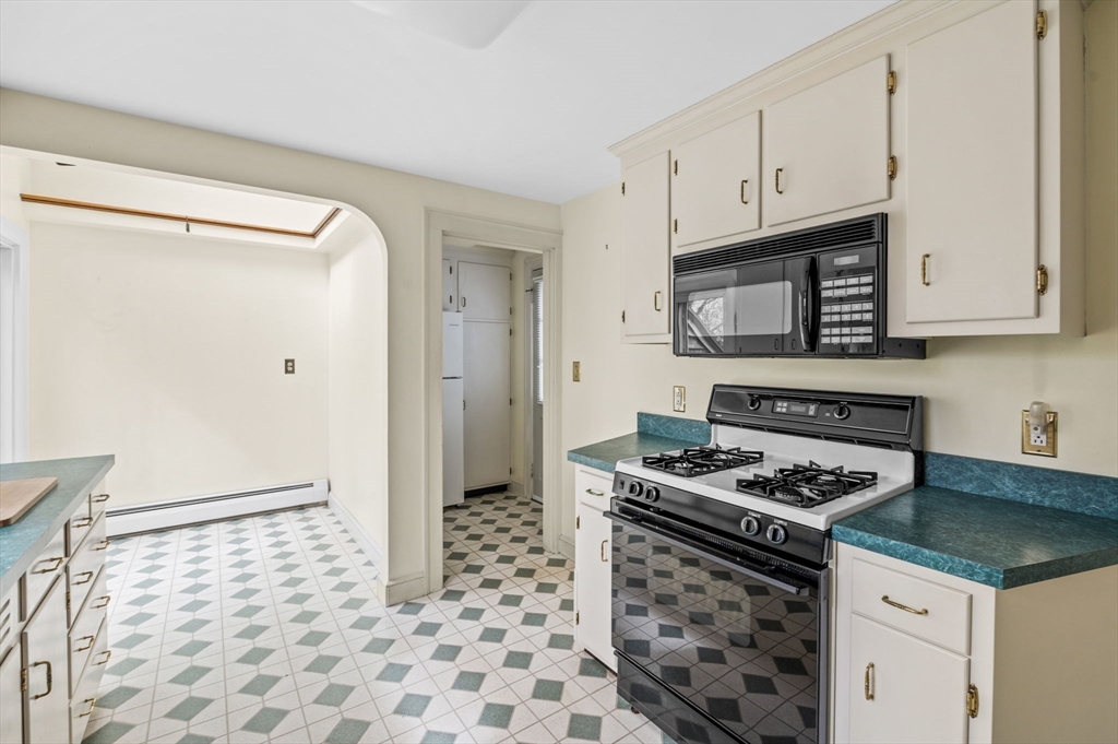 5 Prospect Street Danvers, MA 01923 - Photo 9 of 42 a kitchen with granite countertop a stove sink and cabinets
