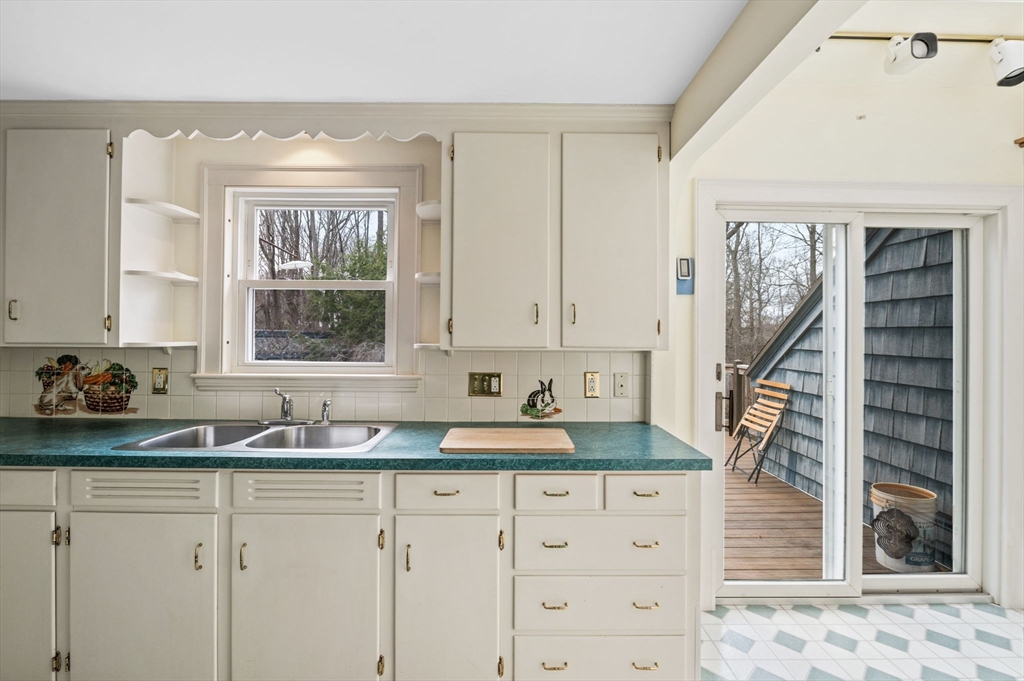 5 Prospect Street Danvers, MA 01923 - Photo 10 of 42 a kitchen with granite countertop a sink a window and cabinets