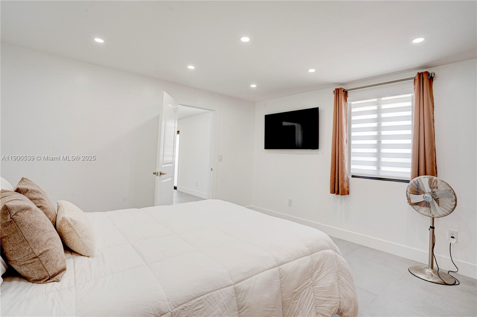 20407 Southwest 226th Street Miami, FL 33170 - Photo 66 of 71 a bedroom with a bed and a flat screen tv