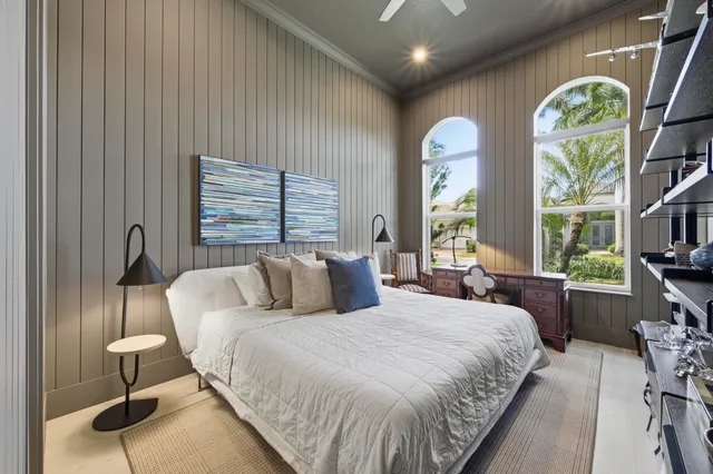 a bedroom with a bed and a painting on the wall