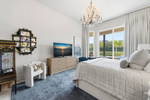 a bedroom with bed and flat tv screen