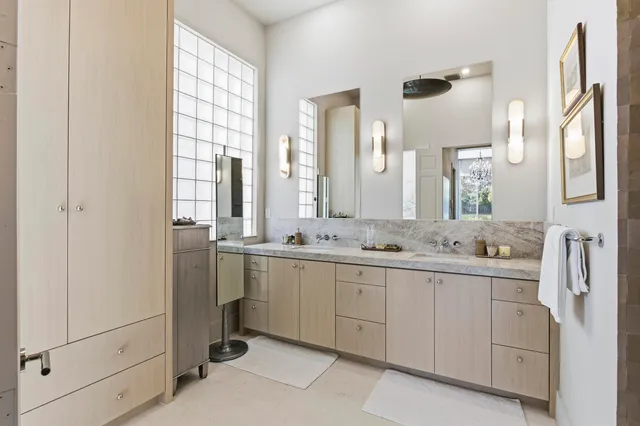 a bathroom with a double vanity sink and mirror