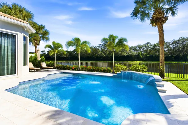 a view of a backyard with swimming pool