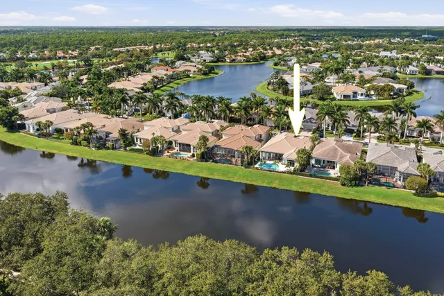 an aerial view of a city with lots of residential buildings ocean and mountain view in back