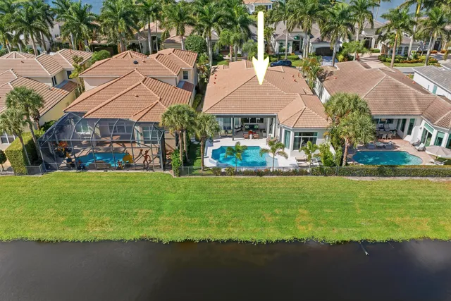 a view of a town with lawn chairs and large trees