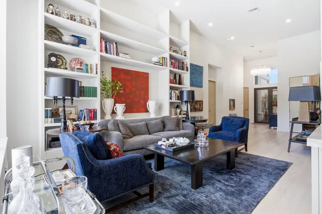 a living room with furniture and a book shelf