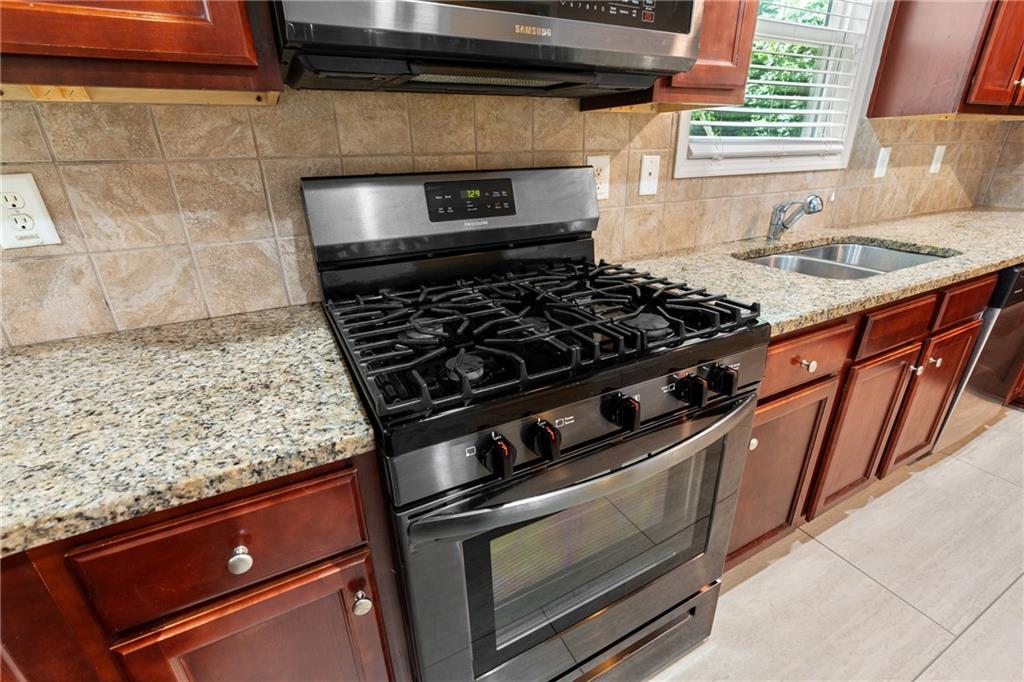 3159 Robinson Avenue Scottdale, GA 30079 - Photo 16 of 45 a stove top oven sitting inside of a kitchen