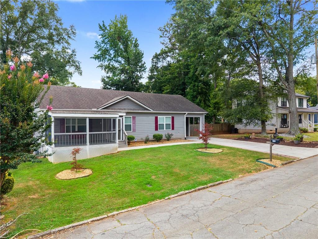3159 Robinson Avenue Scottdale, GA 30079 - Photo 2 of 45 a front view of a house with garden and trees