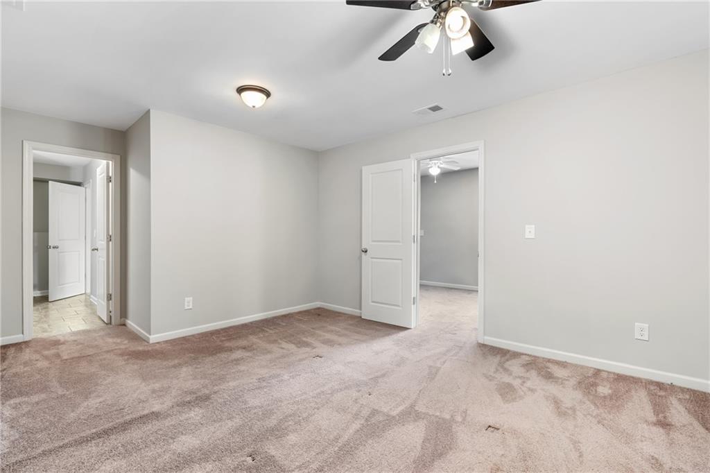 3159 Robinson Avenue Scottdale, GA 30079 - Photo 29 of 45 an empty room with a chandelier fan and closet area