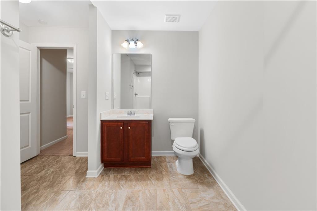 3159 Robinson Avenue Scottdale, GA 30079 - Photo 32 of 45 a bathroom with a toilet a sink and mirror