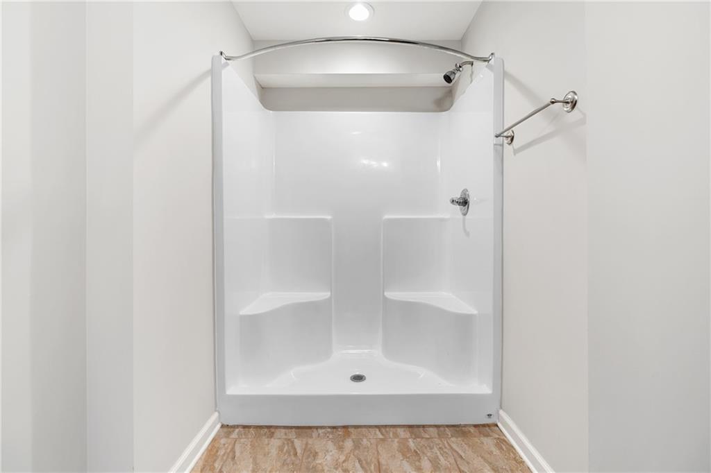 3159 Robinson Avenue Scottdale, GA 30079 - Photo 33 of 45 a bathroom with a glass shower door