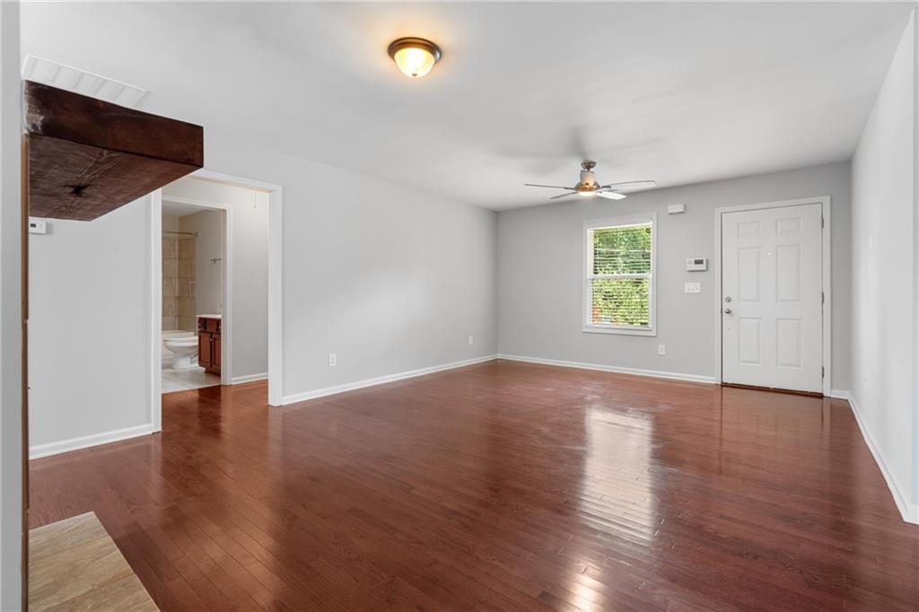 3159 Robinson Avenue Scottdale, GA 30079 - Photo 8 of 45 an empty room with windows and chandelier fan