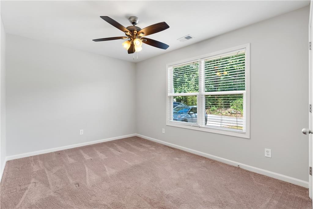 3159 Robinson Avenue Scottdale, GA 30079 - Photo 9 of 45 an empty room with a window and a fan