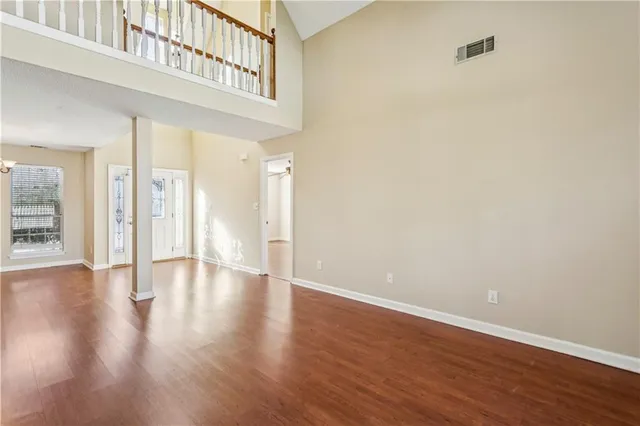 a view of an empty room with wooden floor