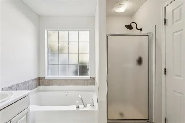 a bathroom with bathtub next to a window