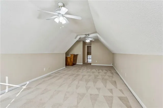 a view of a livingroom with a ceiling fan and chandelier fan