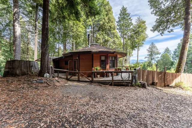 a view of a house with a yard and sitting area
