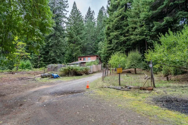a view of a house with a yard and sitting area
