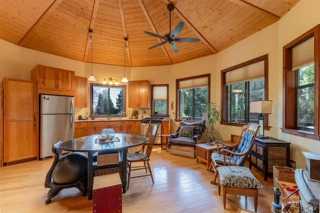 a dining room with furniture a chandelier and wooden floor