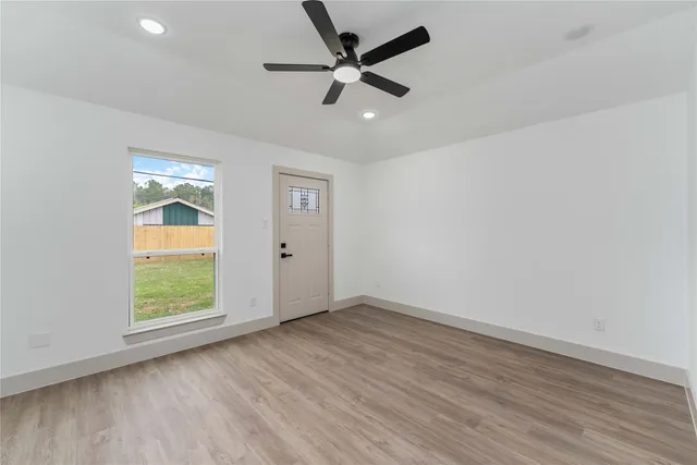 wooden floor in an empty room with a window
