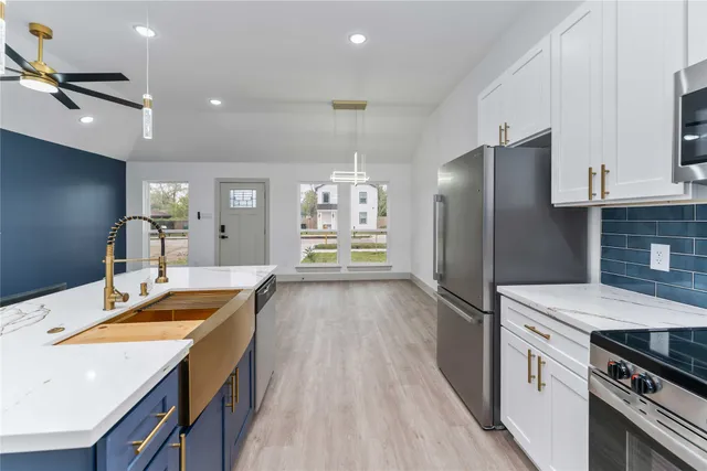 a kitchen with a sink stove and refrigerator