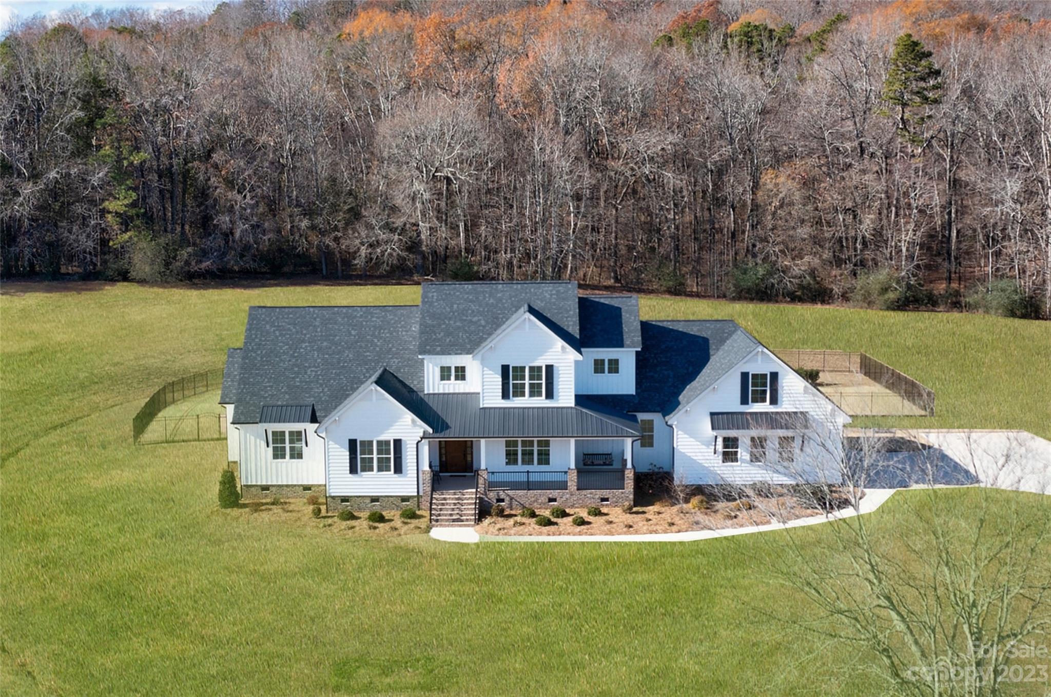 a aerial view of a house with swimming pool and a yard