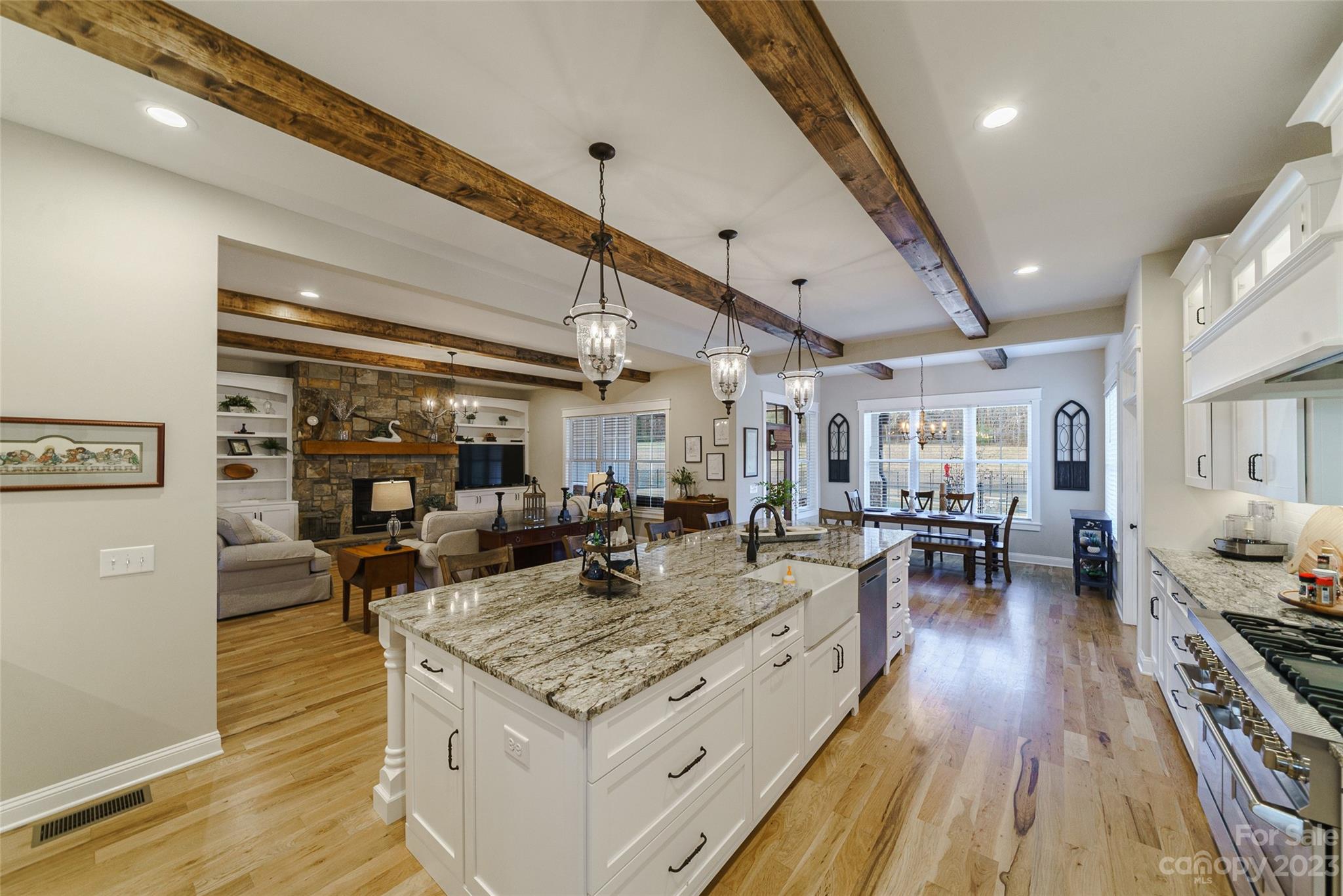 16063 McLester Road Oakboro, NC 28129 - Photo 15 of 48 a view of a big room with dining table chairs and wooden floor